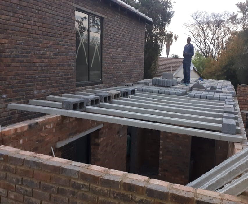 Rib and block lintels being layed on a double story building